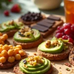 Best vegan snacks spread on a wooden board with roasted chickpeas, rice cakes, dark chocolate-covered fruit, and trail mix.